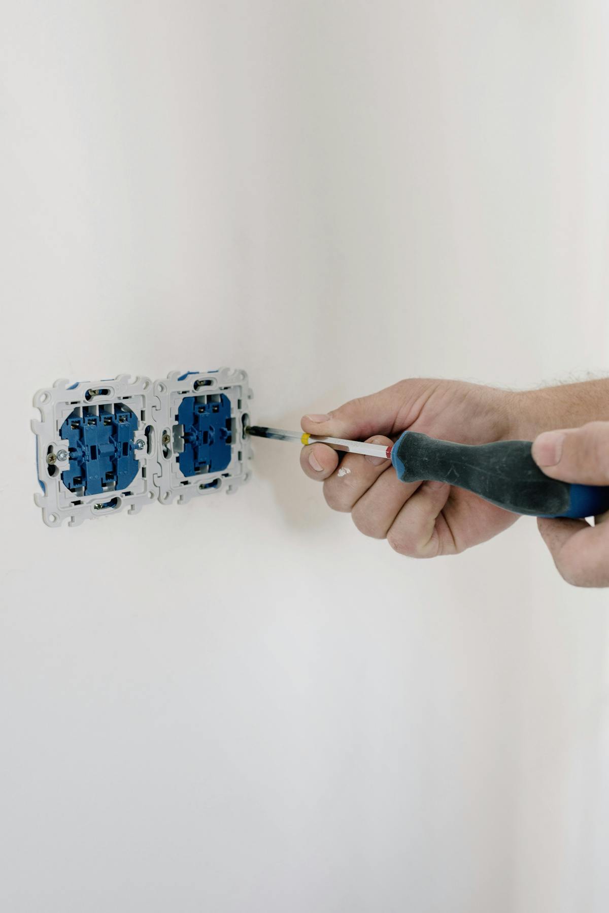 Electrician installing an outlet in a home